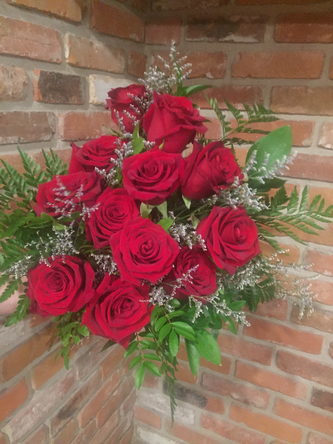 One dozen of our premium Explorer Red Roses hand tied with an assortment of foliages and whispy lavender limonium for a touch of soft romance. Ready for your recipient to drop in their vase