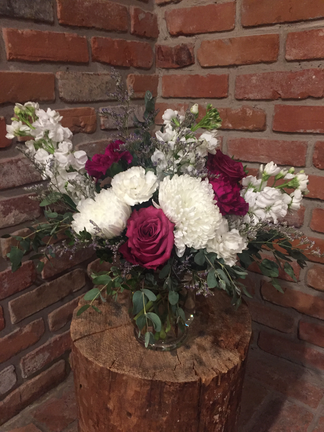 A beautiful garden style vase arrangement including a jumbo white hydrangea, fragrant white stocks, blueberry roses and plum and white carnations. A touch of whispy lavender limonium and an assortment of foliages add loads of texture!