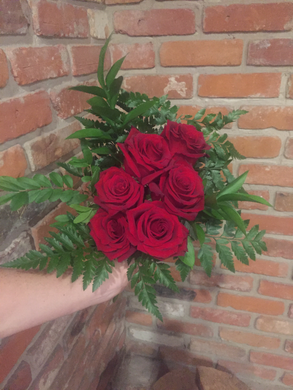 Half dozen of our premium Explorer Red Roses hand tied with an assortment of foliages ready for your recipient to drop in their vase!
