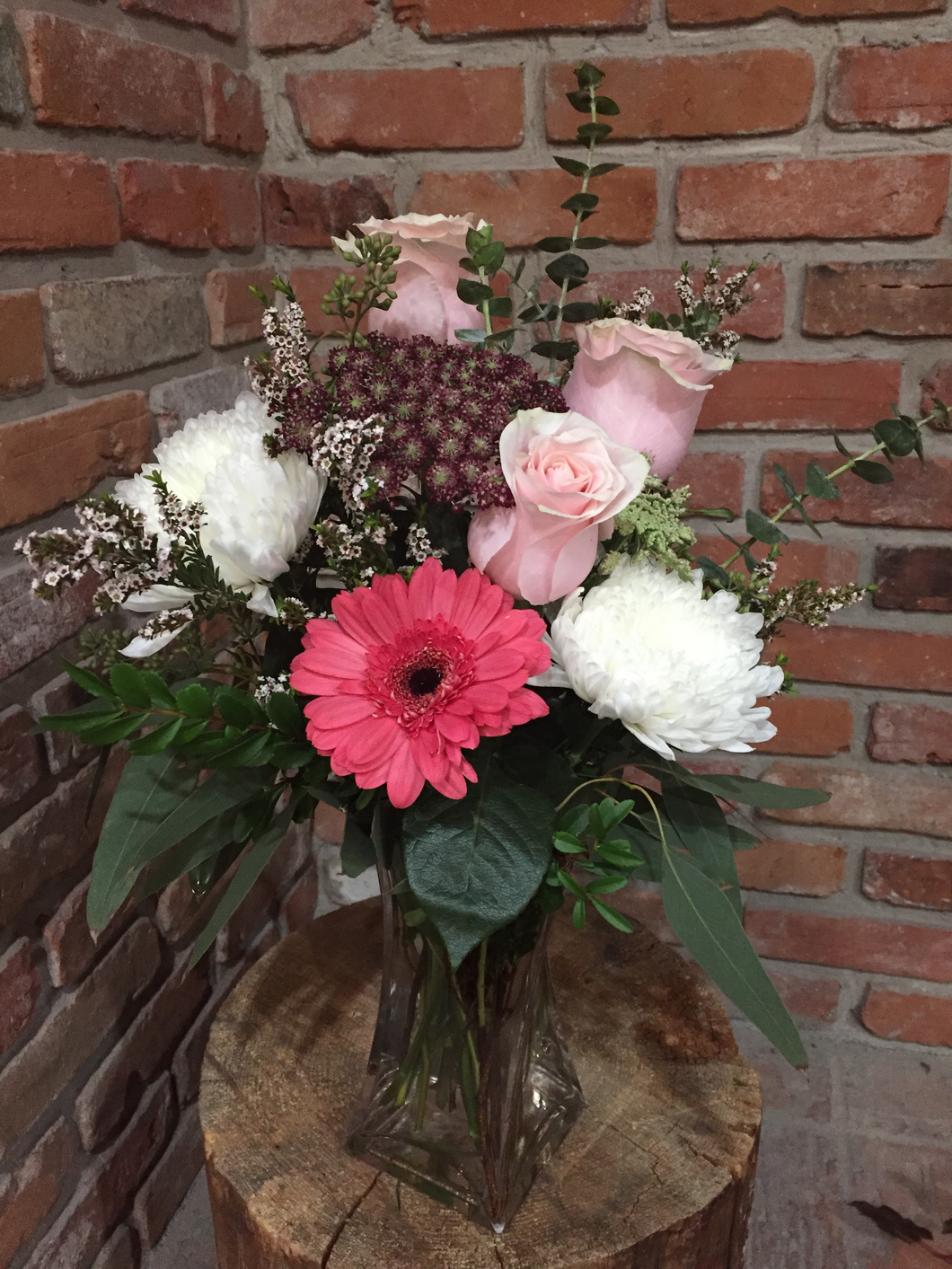 A popular choice full of texture! Shades of pink in roses and Gerber daisy with white Cremons and a variety of fillers and premium foliages