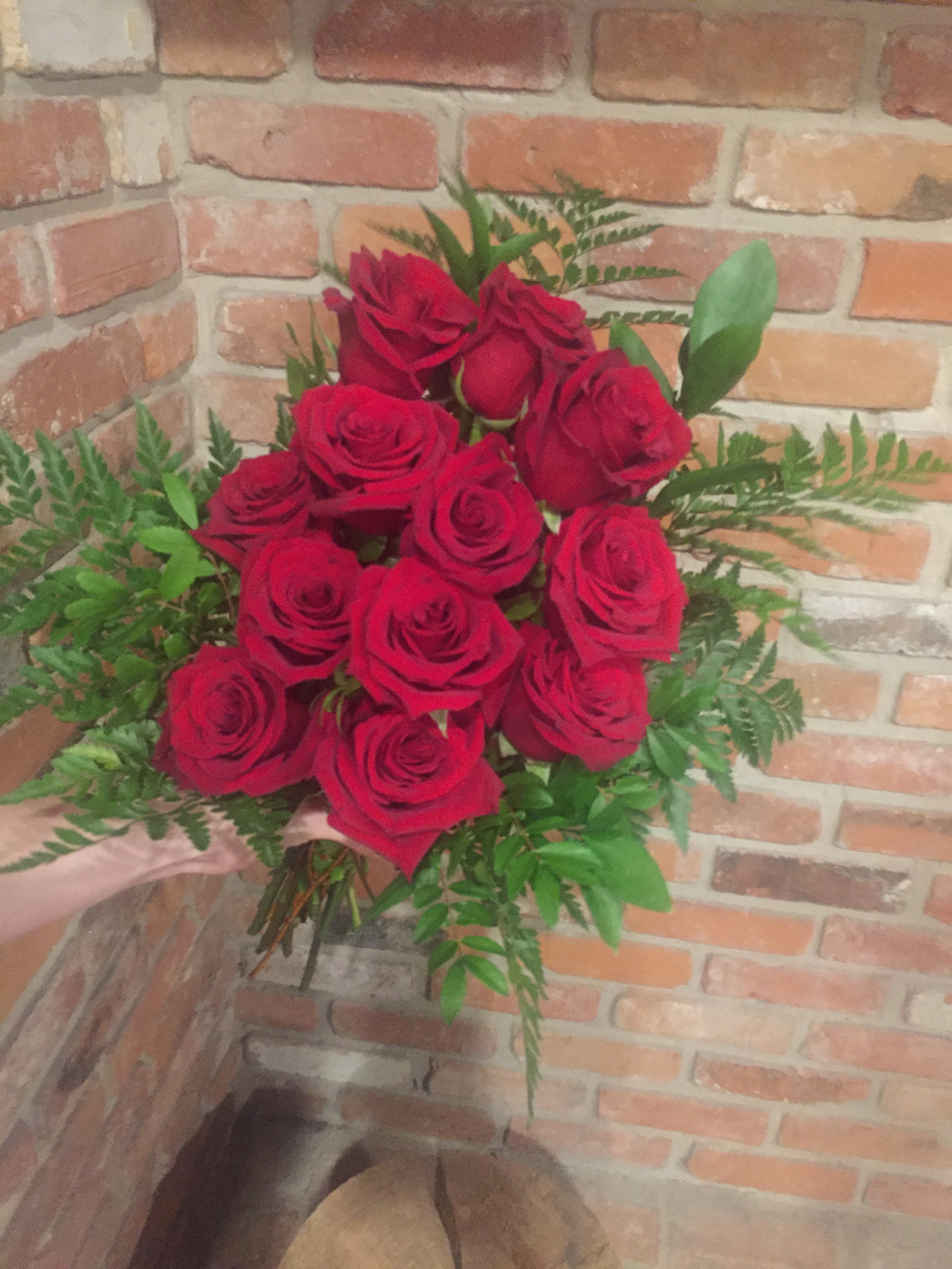 One dozen of our premium Explorer Red Roses hand tied with an assortment of foliages. Ready for your recipient to drop in their vase